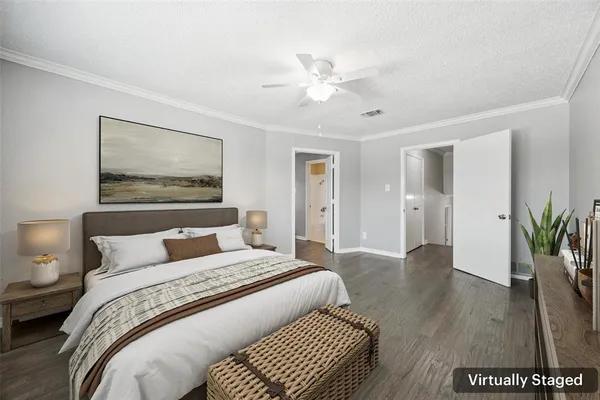 a bedroom with a large bed and a chandelier