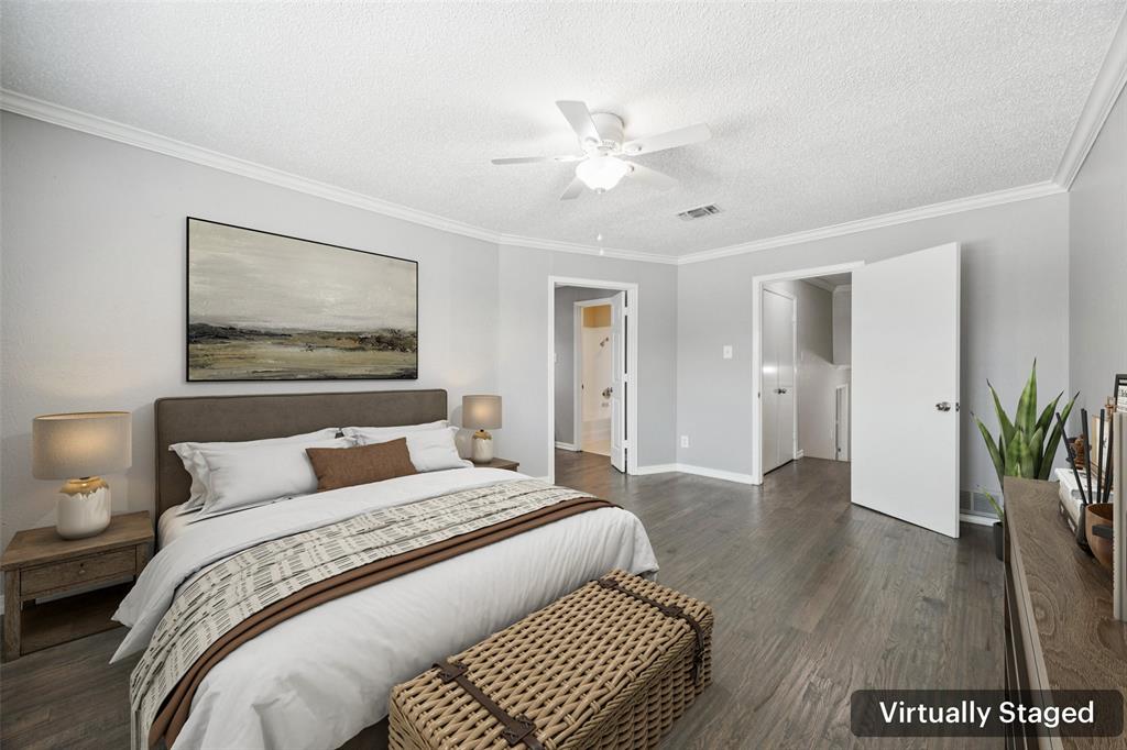 207 East Harwood Road, Unit 14 Euless, TX 76039 - Photo 16 of 28 a bedroom with a large bed and a chandelier
