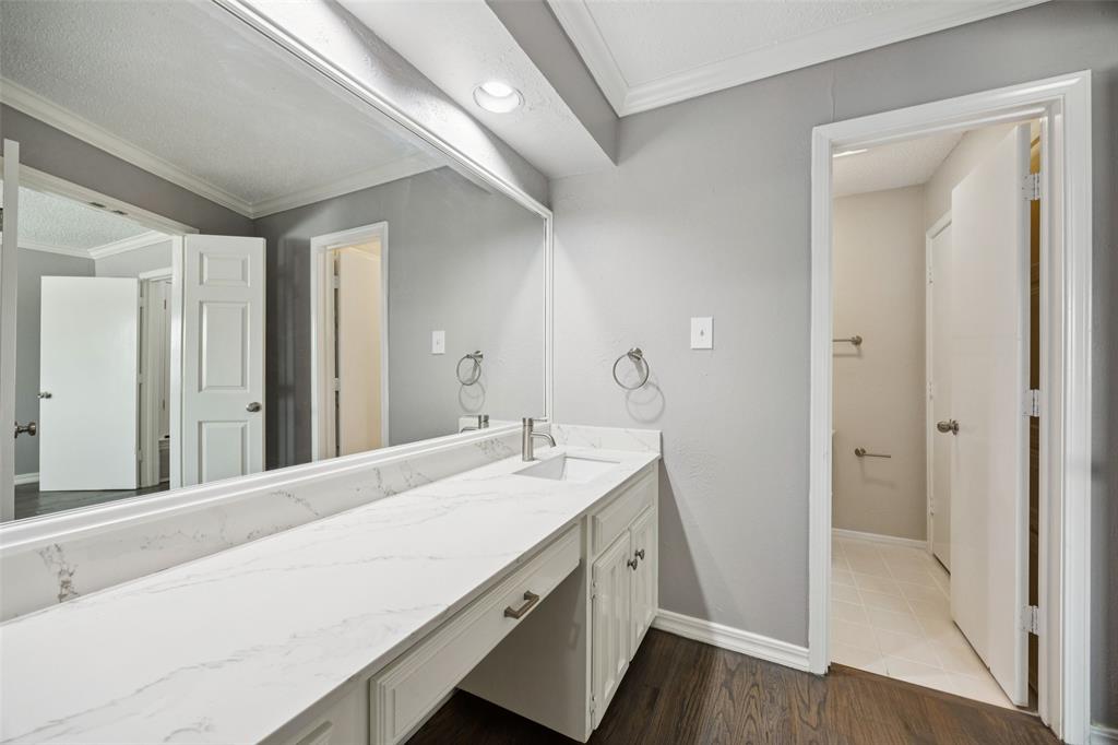 207 East Harwood Road, Unit 14 Euless, TX 76039 - Photo 20 of 28 a bathroom with a sink and a mirror