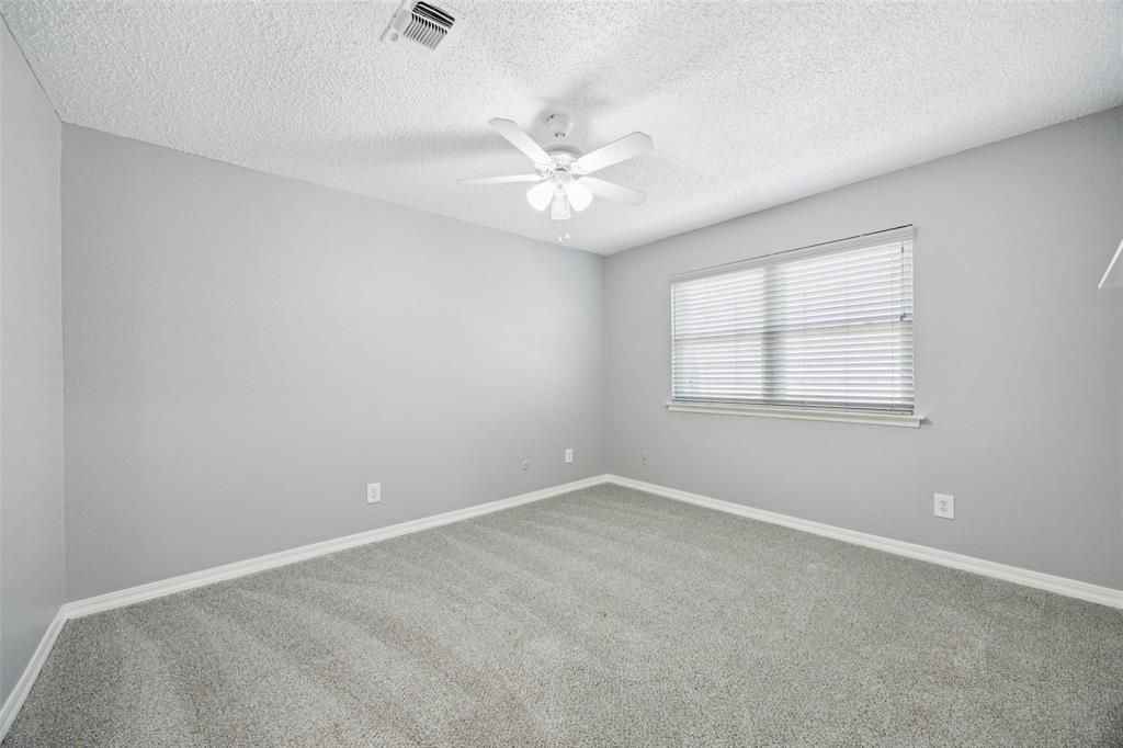 207 East Harwood Road, Unit 14 Euless, TX 76039 - Photo 22 of 28 an empty room with a window and a fan