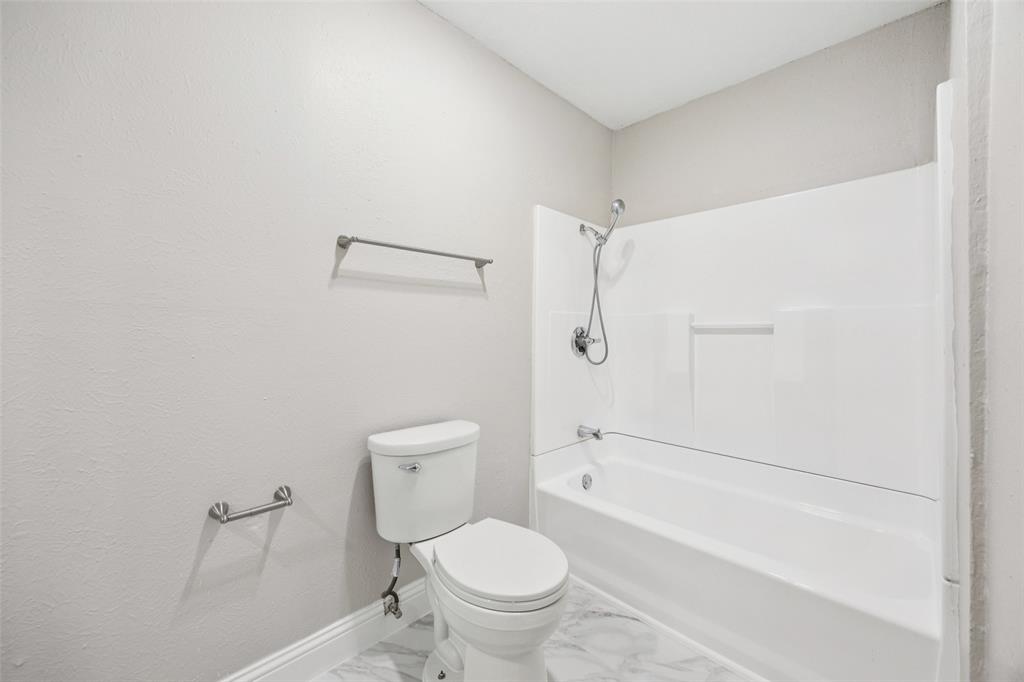 207 East Harwood Road, Unit 14 Euless, TX 76039 - Photo 25 of 28 a bathroom with a toilet and a shower