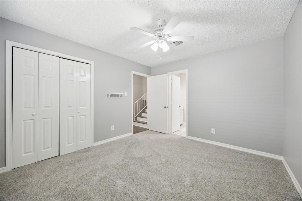 207 East Harwood Road, Unit 14 Euless, TX 76039 - Photo 25 of 28 a view of an empty room with a chandelier fan