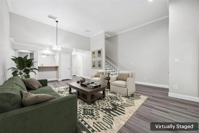 a living room with furniture and wooden floor