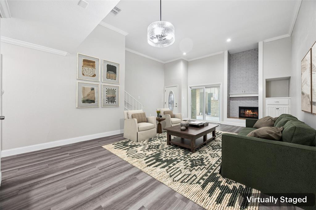 207 East Harwood Road, Unit 14 Euless, TX 76039 - Photo 7 of 28 a living room with furniture a fireplace and a table
