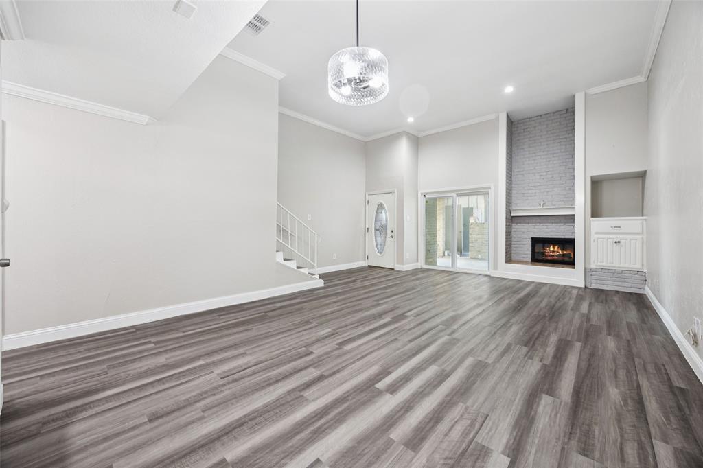 207 East Harwood Road, Unit 14 Euless, TX 76039 - Photo 7 of 28 wooden floor in an empty room with a window