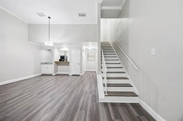 a view of entryway and hall with wooden floor