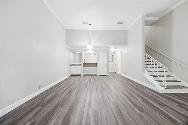 a view of wooden floor and windows in a room