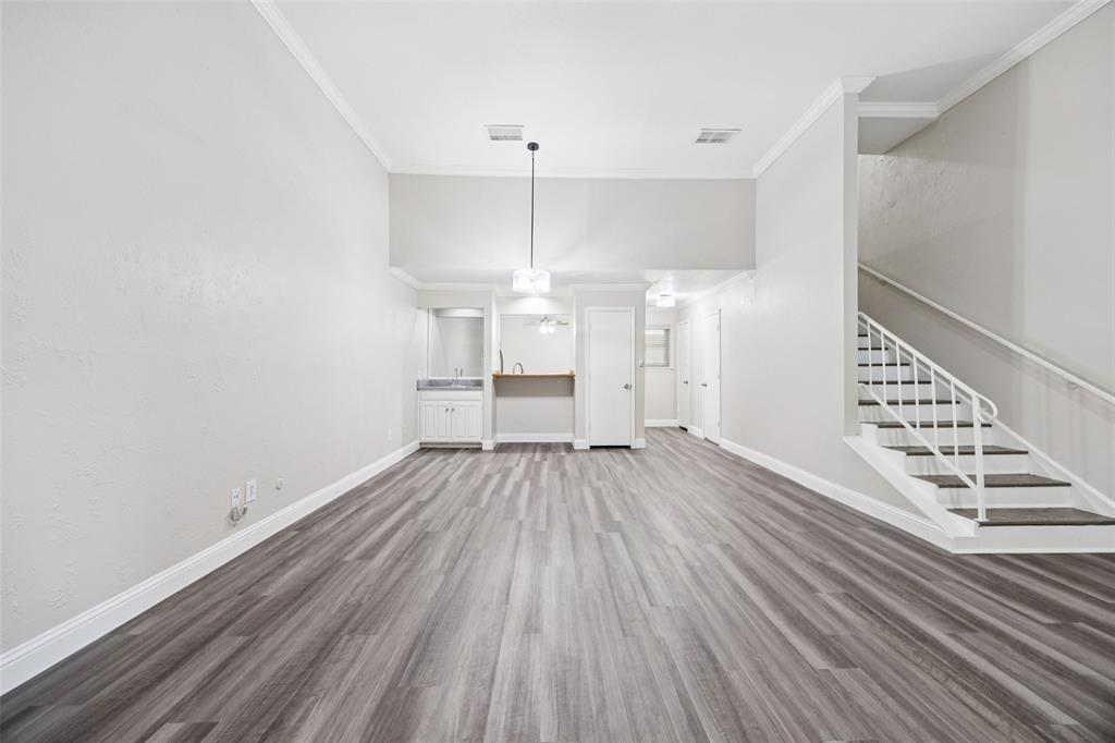 207 East Harwood Road, Unit 14 Euless, TX 76039 - Photo 9 of 28 a view of wooden floor and windows in a room