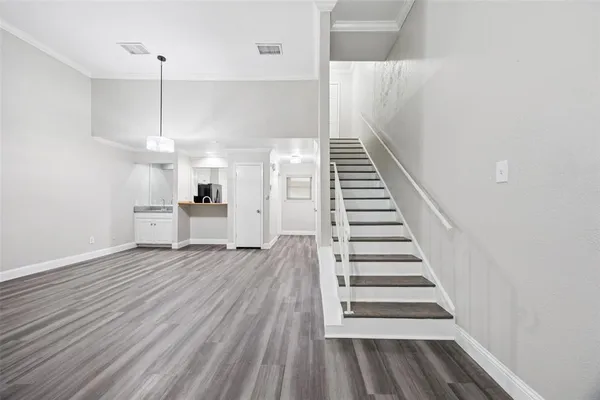 a view of entryway and hall with wooden floor