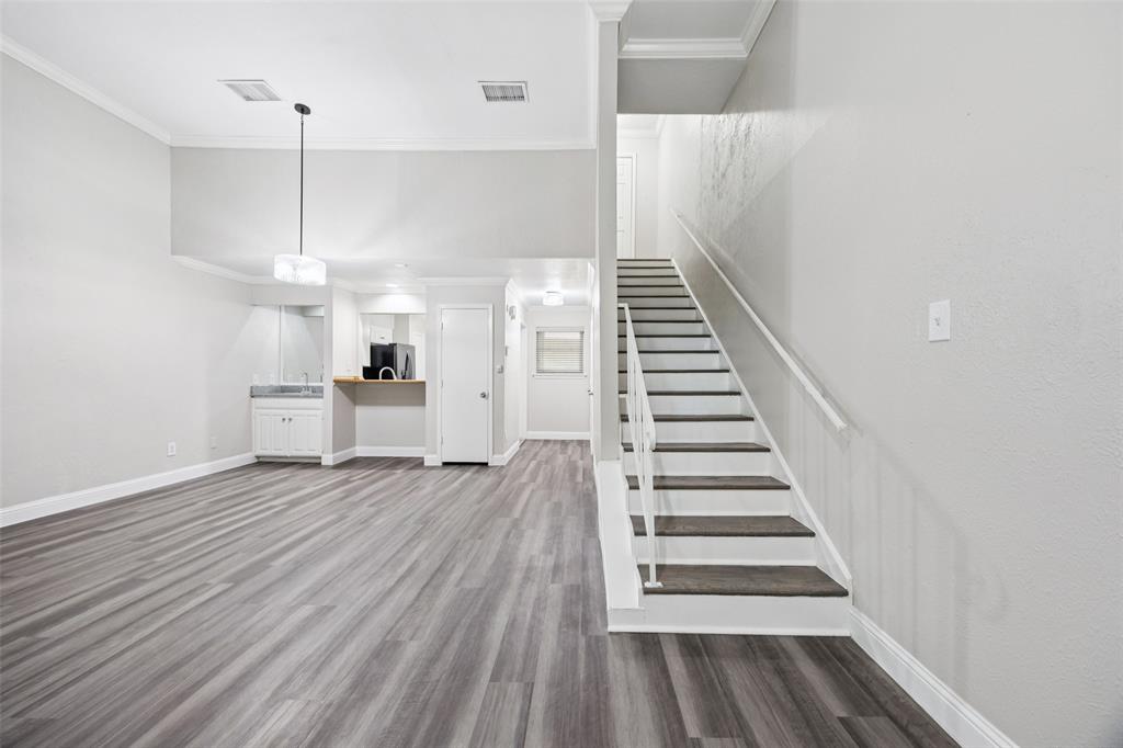 207 East Harwood Road, Unit 14 Euless, TX 76039 - Photo 9 of 28 a view of entryway and hall with wooden floor