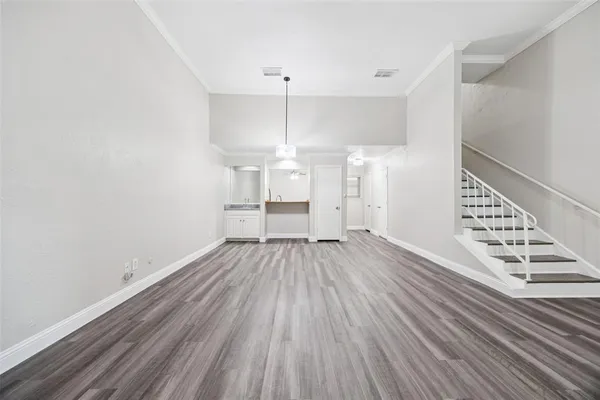a view of wooden floor and windows in a room