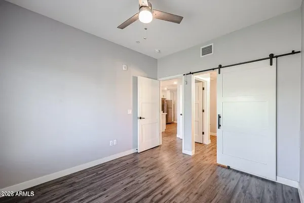 a view of an empty room with wooden floor
