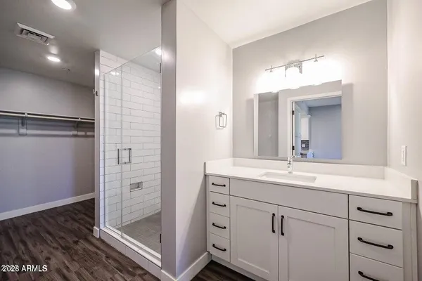 a bathroom with a shower sink and mirror