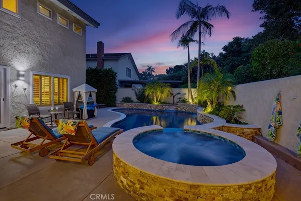 a view of a patio with couches table and chairs and potted plants