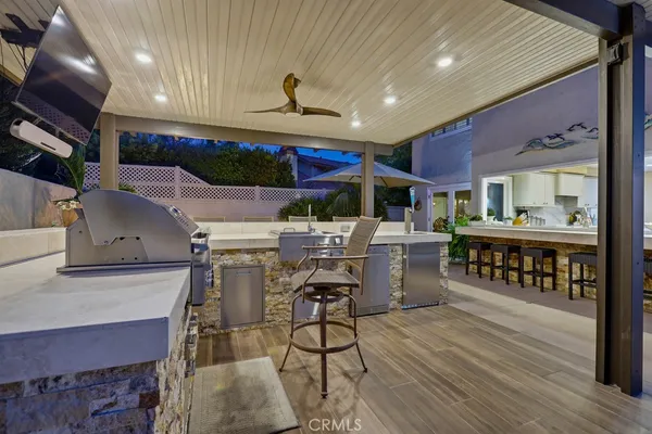 a view of a patio with table and chairs under an umbrella