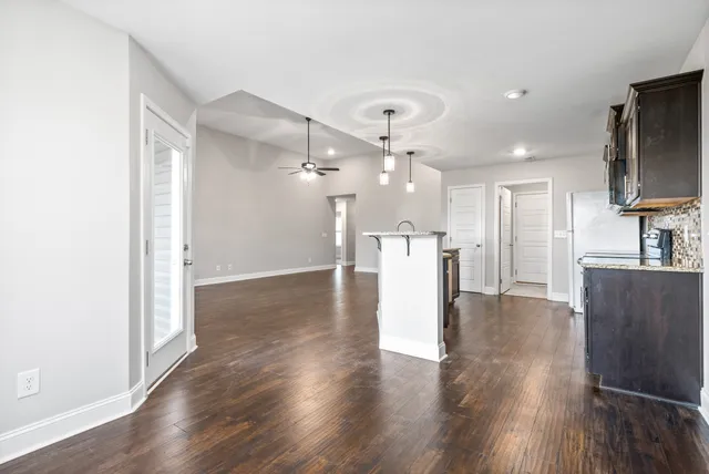 a view of a kitchen with a sink and a refrigerator