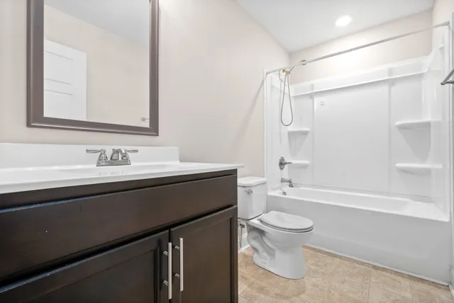 a bathroom with a sink a toilet and a large mirror