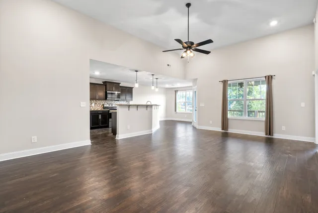 a view of a kitchen with a dishwasher cabinets and wooden floor