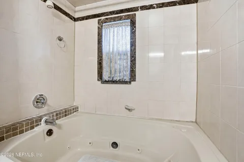 a bathroom with a tub and a shower