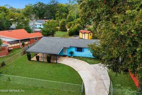 an aerial view of a house with a swimming pool