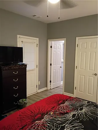 a bedroom with a bed and a flat screen tv
