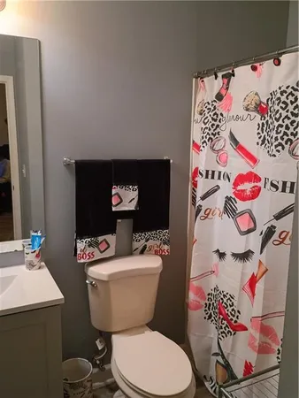 a white toilet sitting next to a bathroom sink