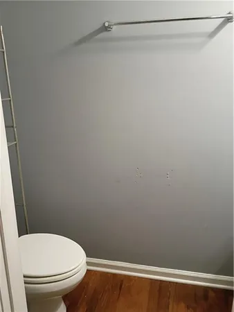 a white toilet sitting next to a shower