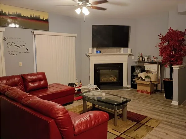 a living room with furniture a flat screen tv and a fireplace