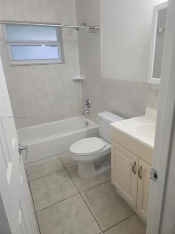 a bathroom with a toilet a sink and a shower
