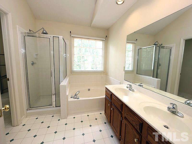 3505 Singleleaf Lane Raleigh, NC 27616 - Photo 7 of 14 a bathroom with a double vanity sink mirror double shower and a bathtub