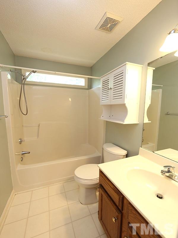 3505 Singleleaf Lane Raleigh, NC 27616 - Photo 9 of 14 a bathroom with a sink a toilet and shower