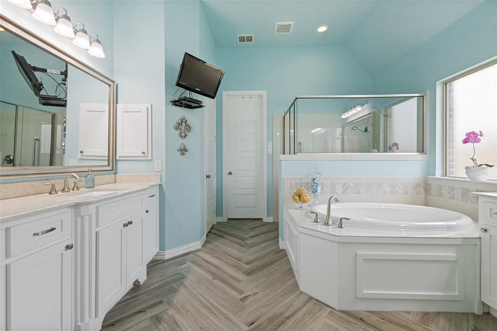 506 Life Spring Drive Rockwall, TX 75087 - Photo 22 of 36 a bathroom with a tub sink and mirror