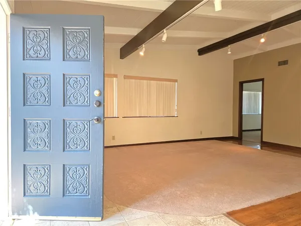 a view of a hallway with a painting on the wall