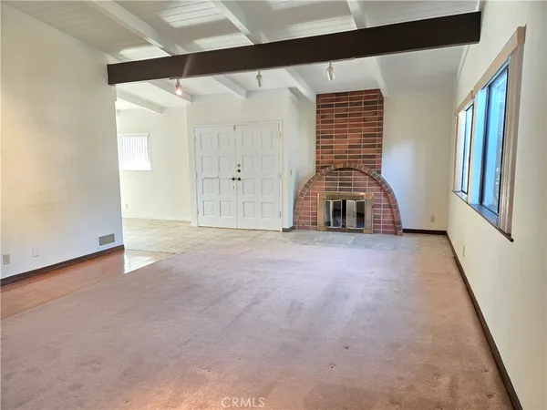 a view of a livingroom with wooden floor and window