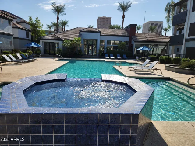 a swimming pool with outdoor seating yard and barbeque oven