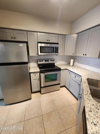 a kitchen with granite countertop cabinets and window