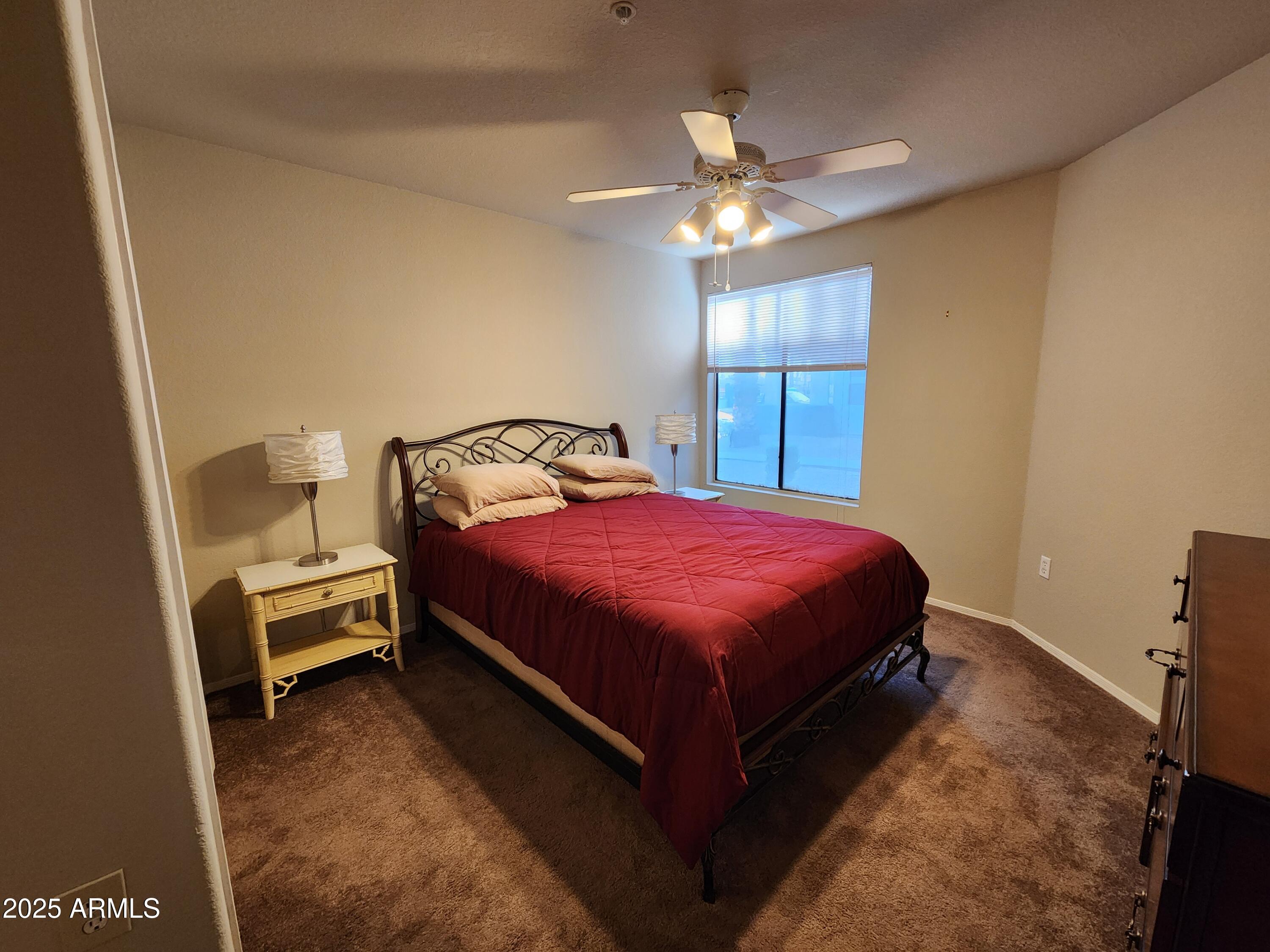 3848 North 3rd Avenue, Unit 1044 Phoenix, AZ 85013 - Photo 6 of 22 a spacious bedroom with a bed and a chandelier