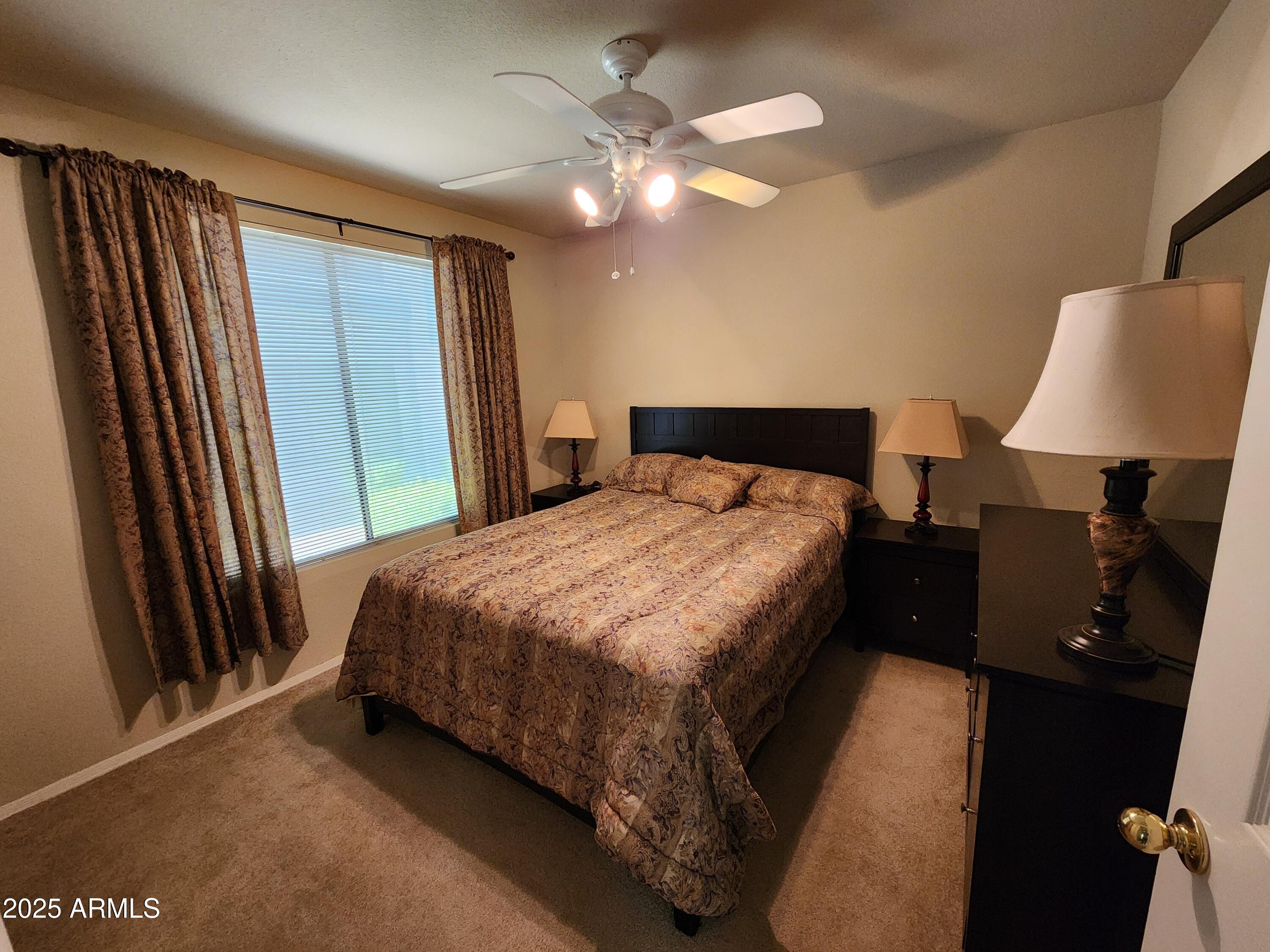 3848 North 3rd Avenue, Unit 1044 Phoenix, AZ 85013 - Photo 9 of 22 a bed sitting in a bedroom next to a window