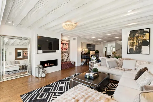 a living room with furniture flat screen tv and a fireplace