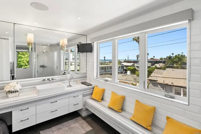 a bathroom with a double vanity sink and a large mirror