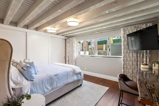 a bedroom with a bed and a flat screen tv