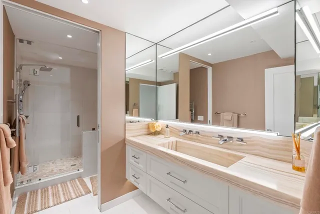 a bathroom with a double vanity sink mirror double and shower