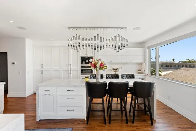 a dining room with furniture and wooden floor
