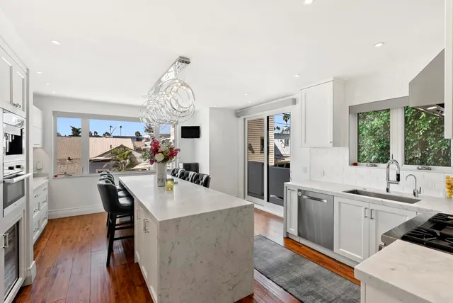 a large kitchen with a table and chairs