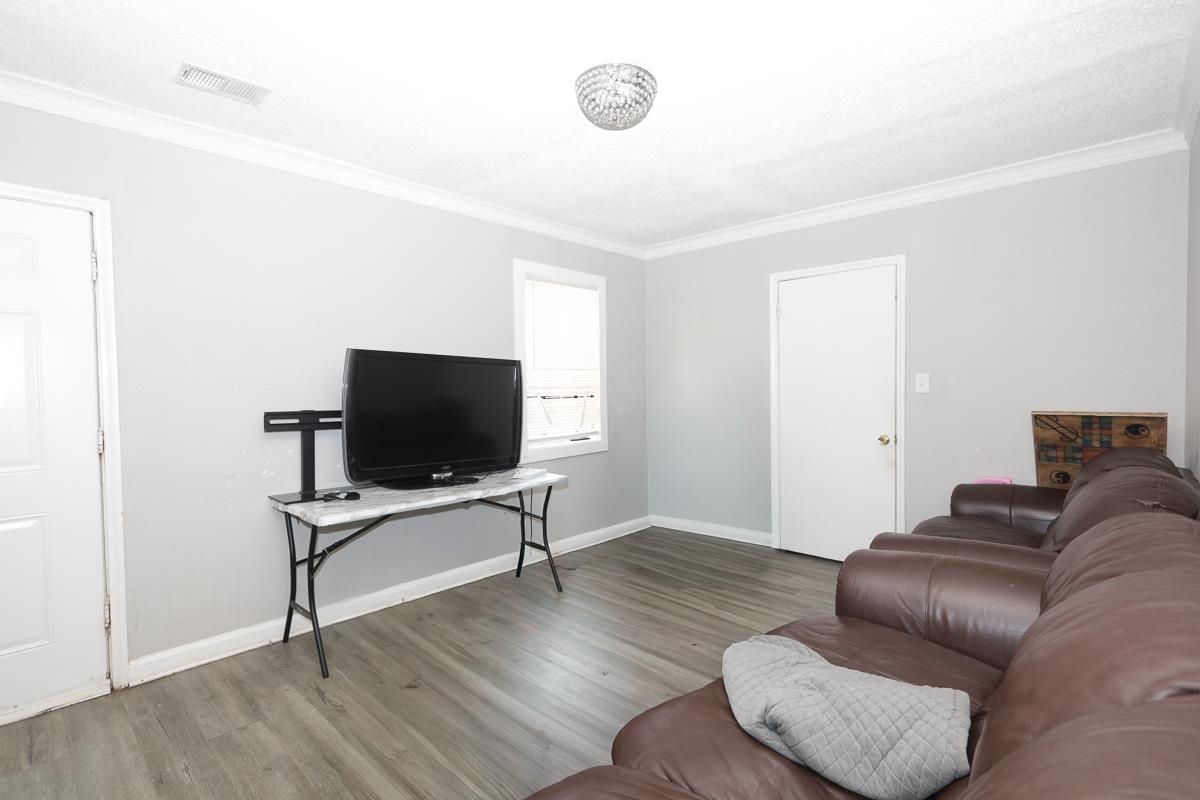 1023 Parkland Road Memphis, TN 38111 - Photo 5 of 13 a living room with furniture and a flat screen tv