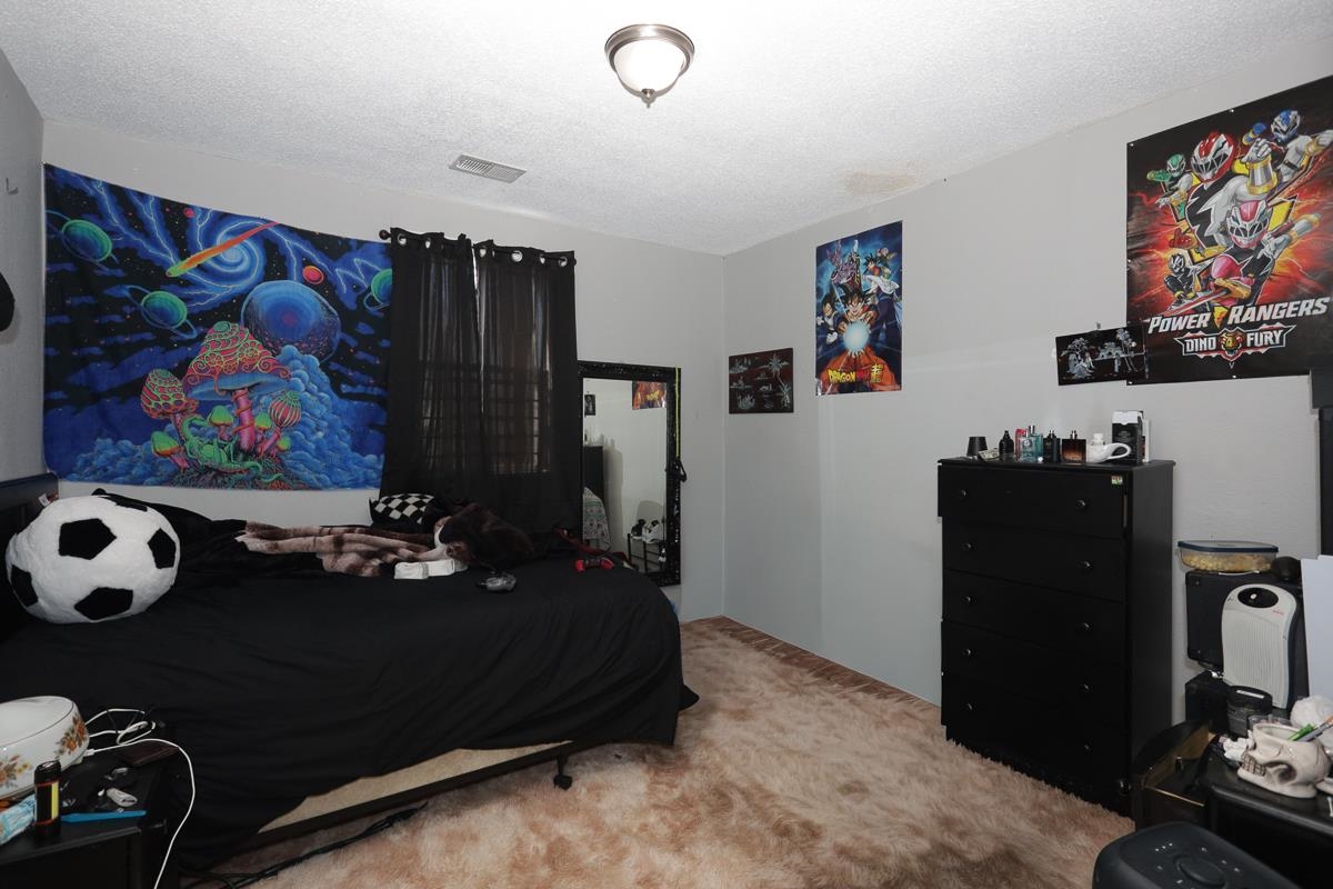 1023 Parkland Road Memphis, TN 38111 - Photo 10 of 13 a living room with furniture and a flat screen tv
