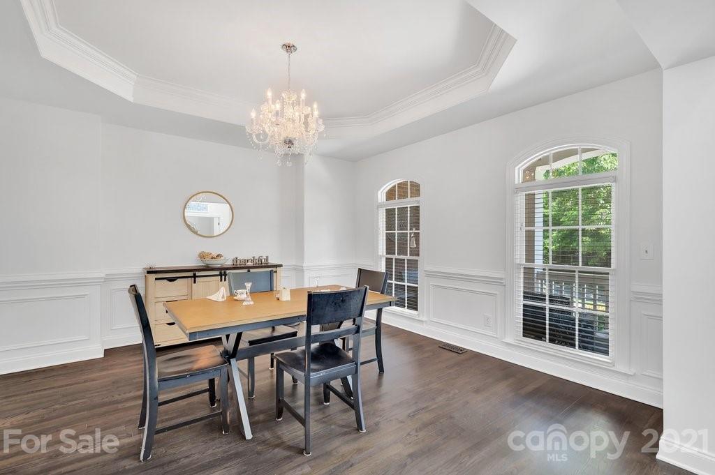 1883 Chestnut Hill Drive Tega Cay, SC 29708 - Photo 11 of 34 a view of a dining room with furniture and a chandelier