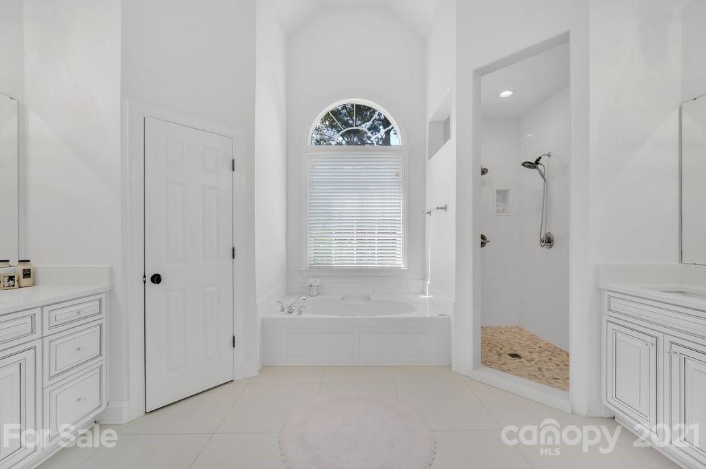 1883 Chestnut Hill Drive Tega Cay, SC 29708 - Photo 16 of 34 a bathroom with a bathtub a shower and a sink