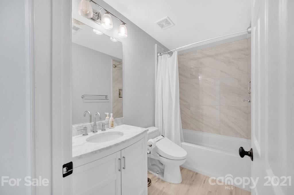 1883 Chestnut Hill Drive Tega Cay, SC 29708 - Photo 21 of 34 a bathroom with a granite countertop sink a toilet and shower