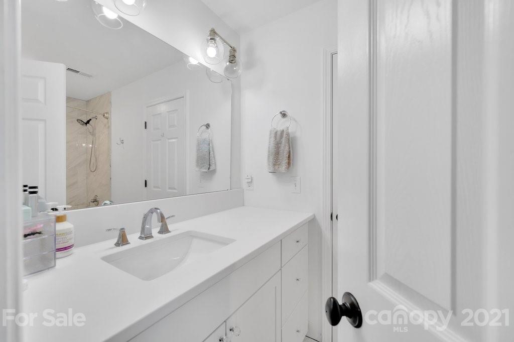 1883 Chestnut Hill Drive Tega Cay, SC 29708 - Photo 23 of 34 a bathroom with a sink and a mirror